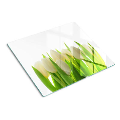 Glass chopping board Tulips against a background of green leaves