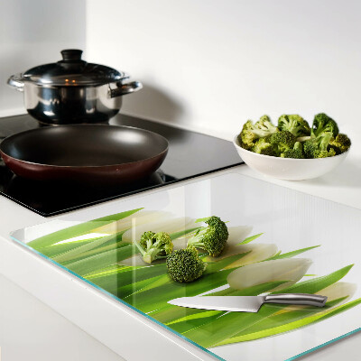 Glass chopping board Tulips against a background of green leaves