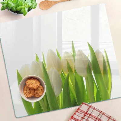 Glass chopping board Tulips against a background of green leaves