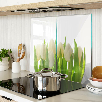 Glass chopping board Tulips against a background of green leaves