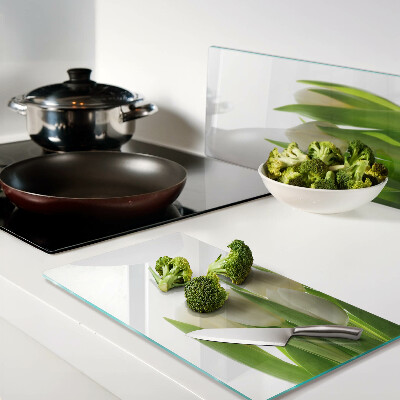 Glass chopping board Tulips against a background of green leaves