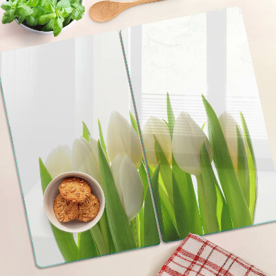 Glass chopping board Tulips against a background of green leaves