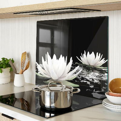 Glass kitchen board Water lilies on a black background