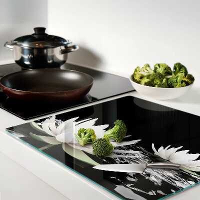 Glass kitchen board Water lilies on a black background