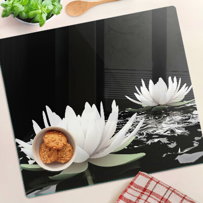 Glass kitchen board Water lilies on a black background