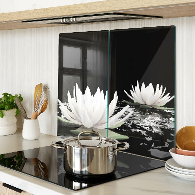 Glass kitchen board Water lilies on a black background