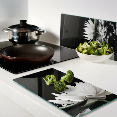 Glass kitchen board Water lilies on a black background