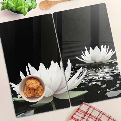 Glass kitchen board Water lilies on a black background