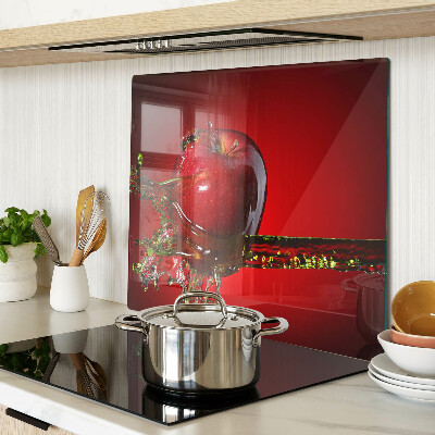 Glass chopping board Red apple with water