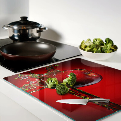 Glass chopping board Red apple with water