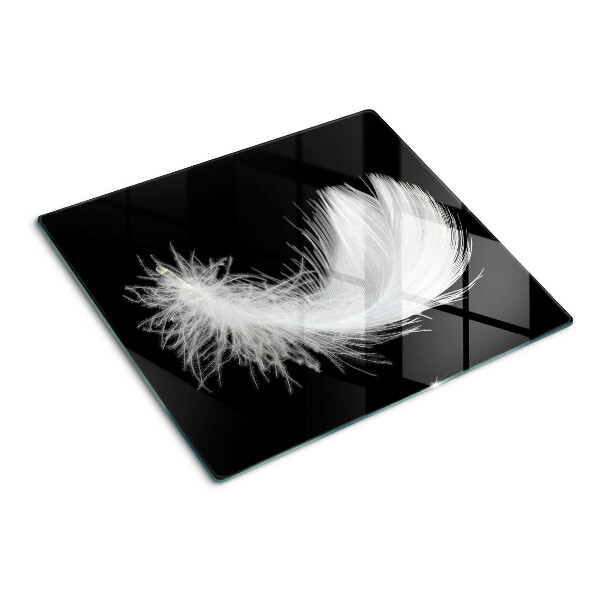 Glass kitchen board Feather on black background