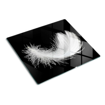 Glass kitchen board Feather on black background