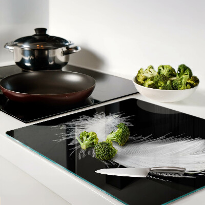 Glass kitchen board Feather on black background