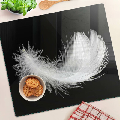 Glass kitchen board Feather on black background