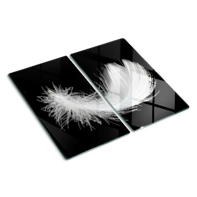 Glass kitchen board Feather on black background