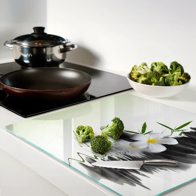 Glass chopping board Flowers and stones on the water