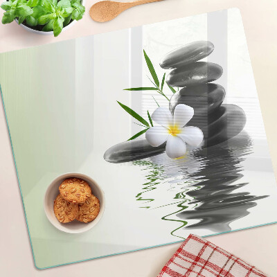 Glass chopping board Flowers and stones on the water