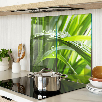 Glass kitchen board Drops of water on the grass