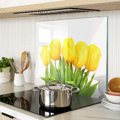 Glass kitchen board Yellow tulips on a green background