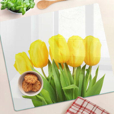 Glass kitchen board Yellow tulips on a green background