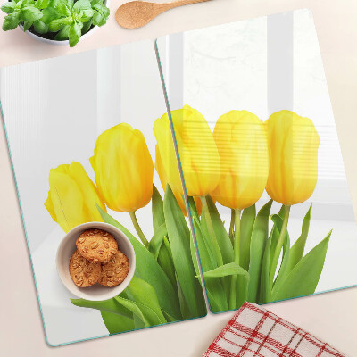 Glass kitchen board Yellow tulips on a green background
