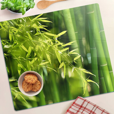 Glass chopping board Bamboo leaves and green foliage