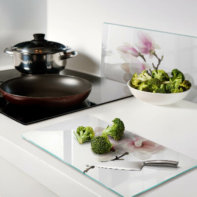 Glass chopping board Magnolia flowers on a branch