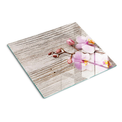 Glass chopping board Orchids on a wood background