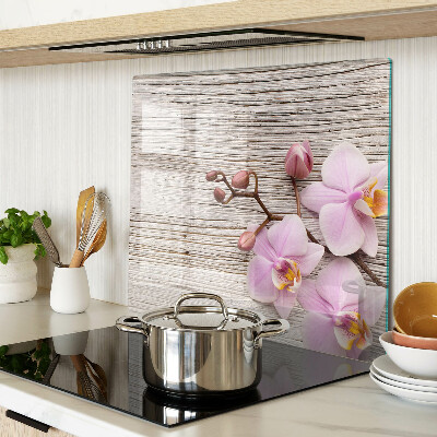 Glass chopping board Orchids on a wood background