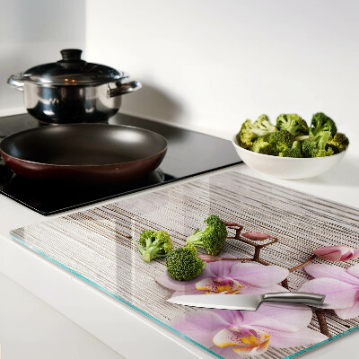 Glass chopping board Orchids on a wood background