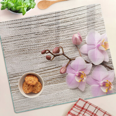 Glass chopping board Orchids on a wood background