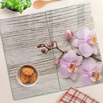 Glass chopping board Orchids on a wood background