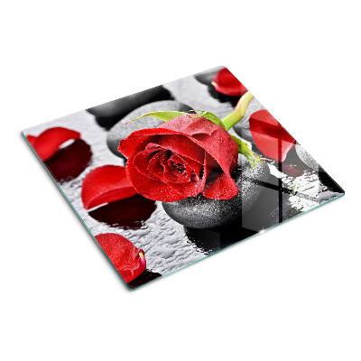 Glass kitchen board Rose on stones with water drops