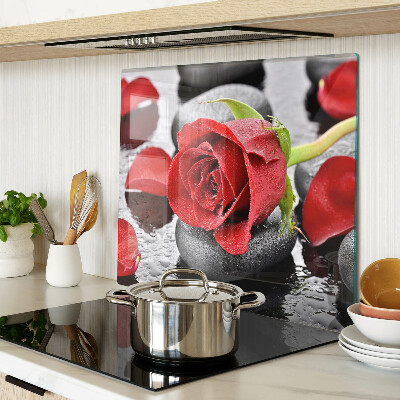 Glass kitchen board Rose on stones with water drops