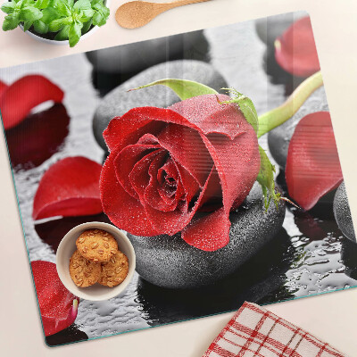 Glass kitchen board Rose on stones with water drops