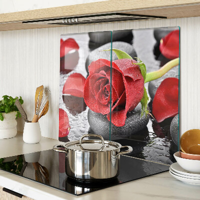 Glass kitchen board Rose on stones with water drops