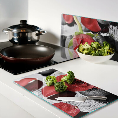 Glass kitchen board Rose on stones with water drops