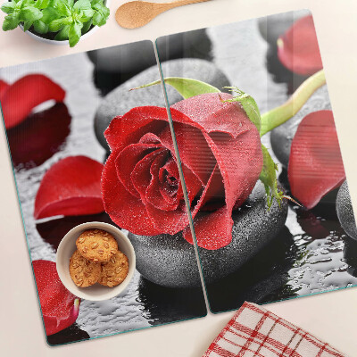 Glass kitchen board Rose on stones with water drops