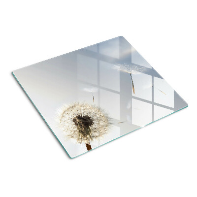 Glass chopping board Dandelions in the background of the window