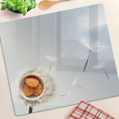 Glass chopping board Dandelions in the background of the window