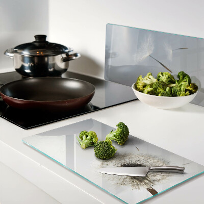 Glass chopping board Dandelions in the background of the window