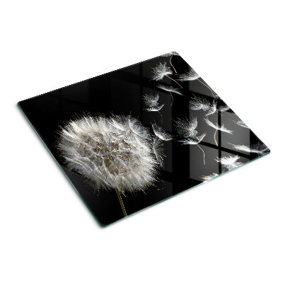 Glass kitchen board Dandelions on a black background