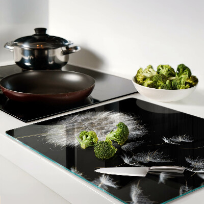 Glass kitchen board Dandelions on a black background