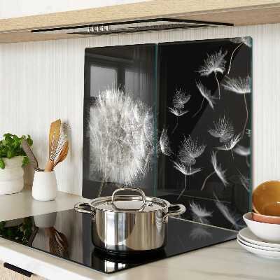 Glass kitchen board Dandelions on a black background