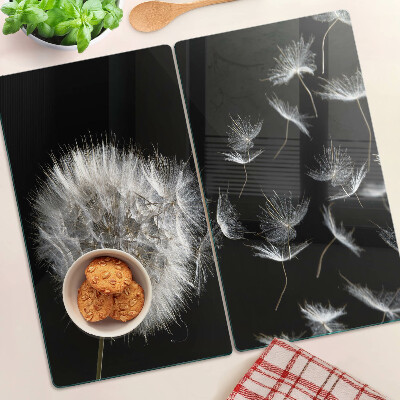 Glass kitchen board Dandelions on a black background