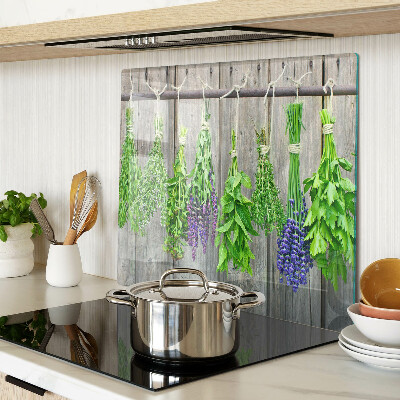 Glass chopping board Dried herbs on a wood background