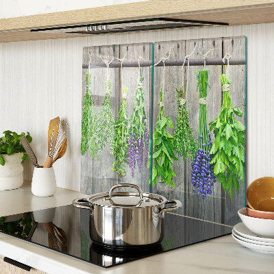Glass chopping board Dried herbs on a wood background