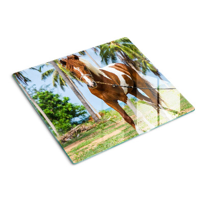Glass chopping board A horse with palm trees in the background