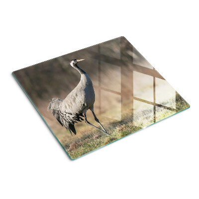 Glass kitchen board A crane against the backdrop of a landscape
