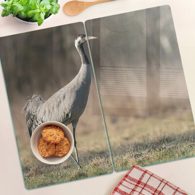 Glass kitchen board A crane against the backdrop of a landscape